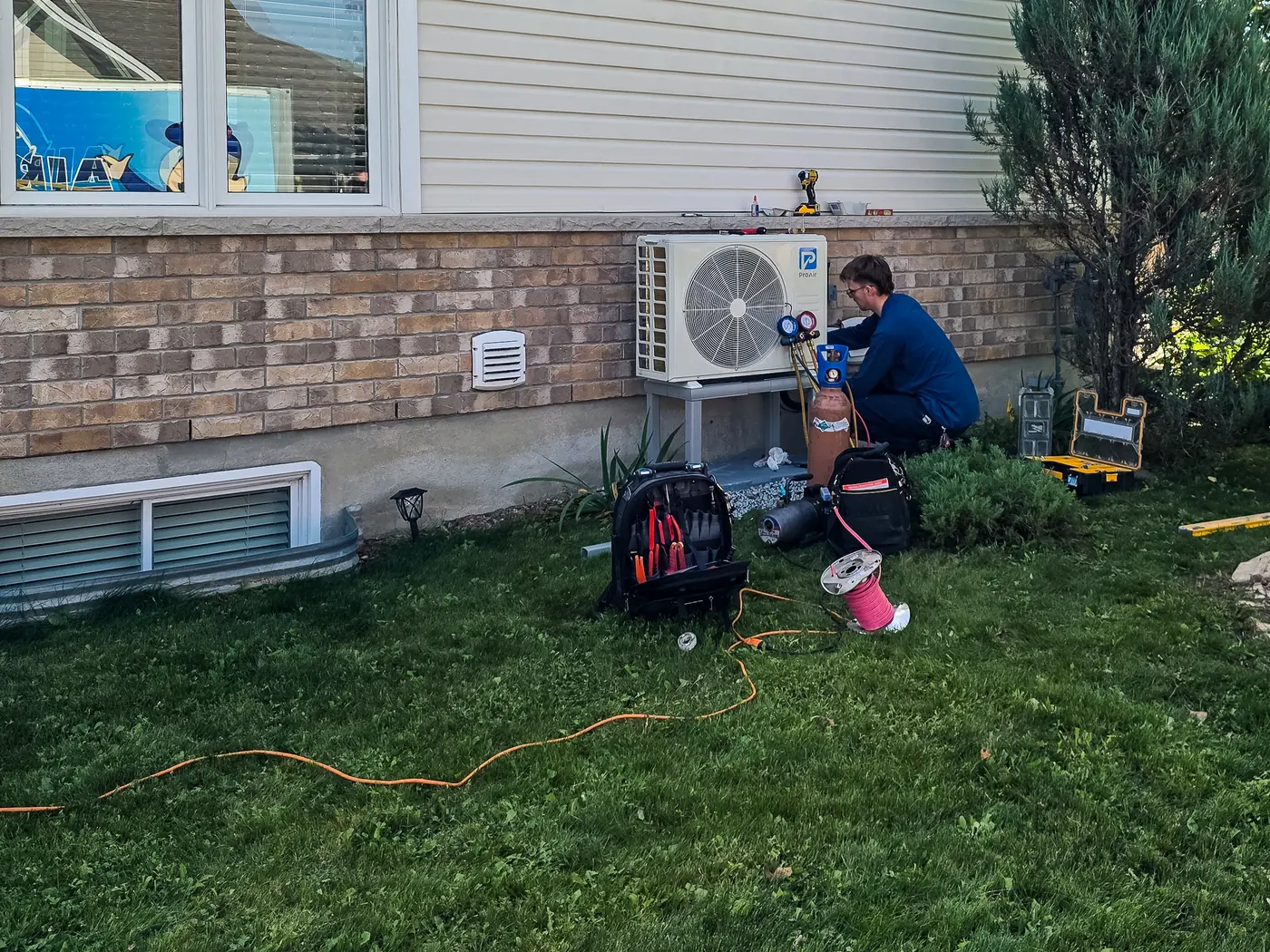 Heat pump technician working on an Ottawa-area installation