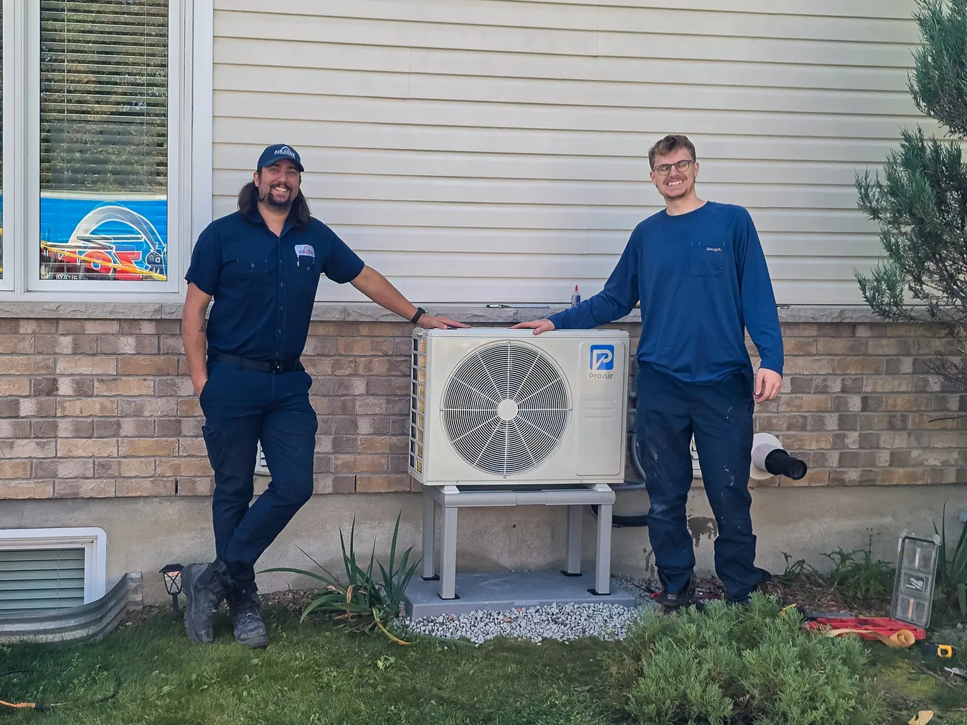 Heat pump installation team beside a completed Ottawa-area heat pump installation